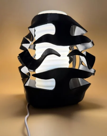 3D Printed Sculptural Ambient Lamp with black flowing exterior and illuminated white centre
