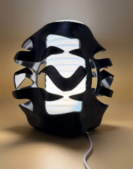 3D Printed Sculptural Ambient Lamp with black flowing exterior and illuminated white centre